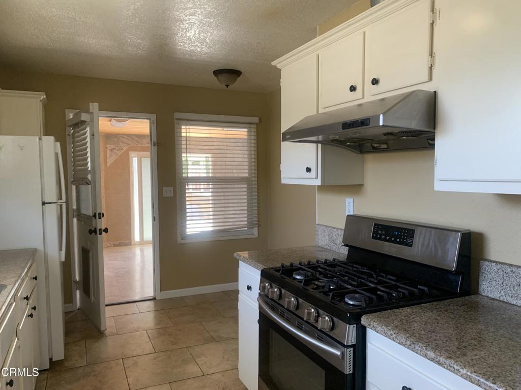 938 Ford Street Corona, CA 92879 - Photo 8 of 36 a kitchen with stainless steel appliances granite countertop a stove and a refrigerator