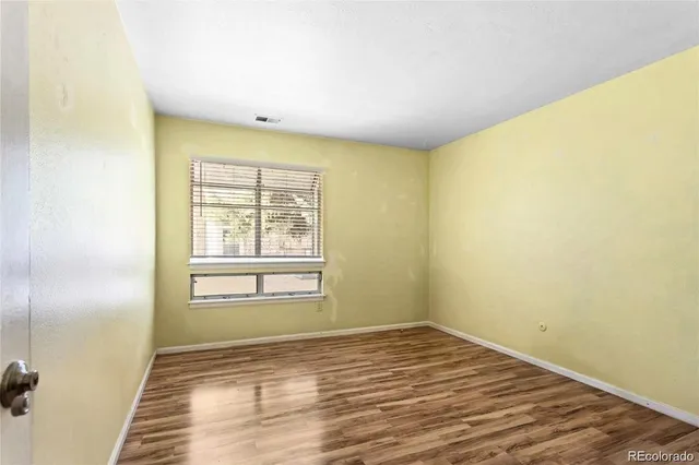 a view of a room with wooden floor