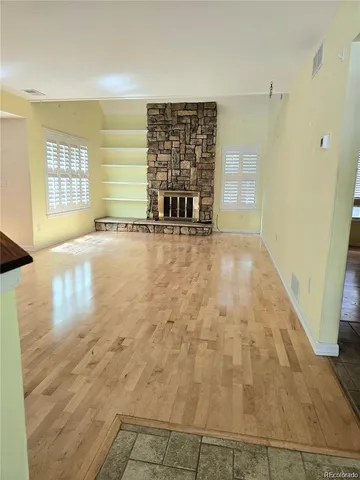 a view of an empty room with a fireplace