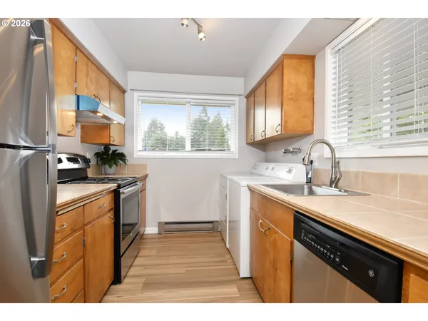 a kitchen with a sink stove and cabinets