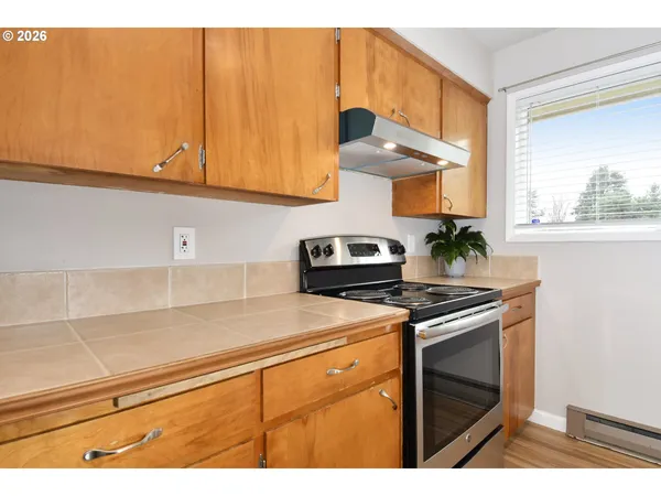 a kitchen with stainless steel appliances a stove a microwave and cabinets