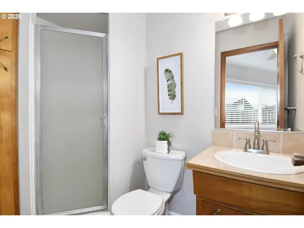 a bathroom with a sink toilet and mirror