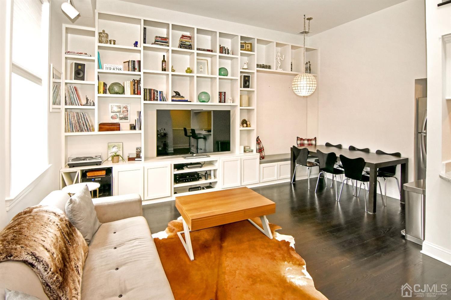 222 Clinton Street, Unit 23 Hoboken, NJ 07030 - Photo 3 of 12 a living room with furniture and a flat screen tv