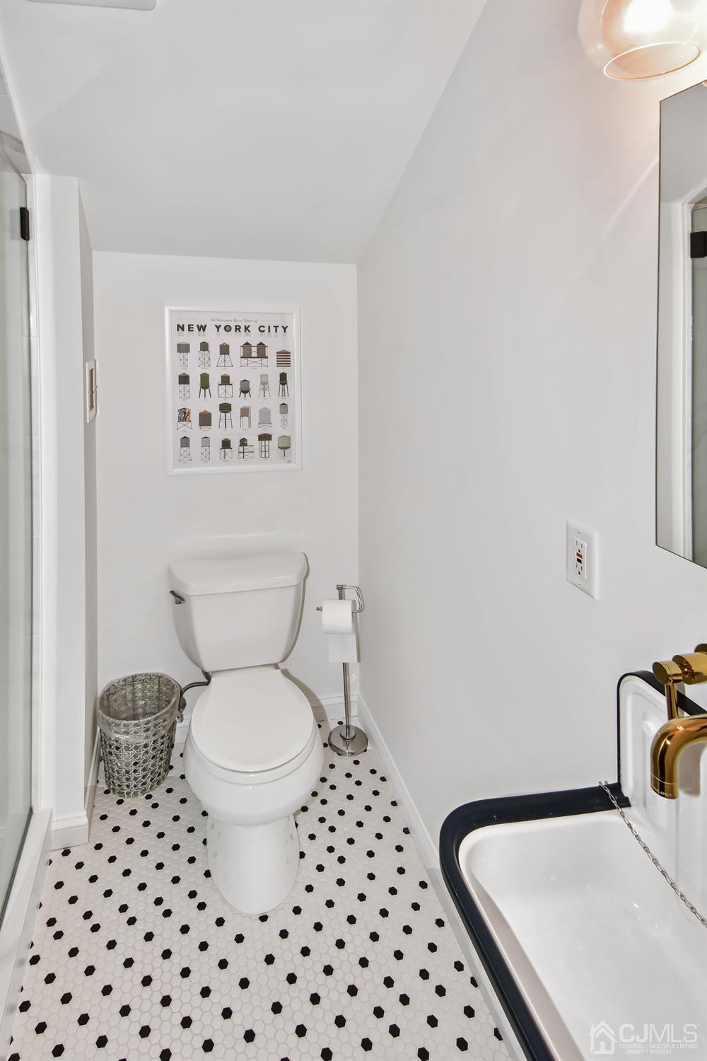 222 Clinton Street, Unit 23 Hoboken, NJ 07030 - Photo 9 of 12 a bathroom with a sink a toilet and a mirror