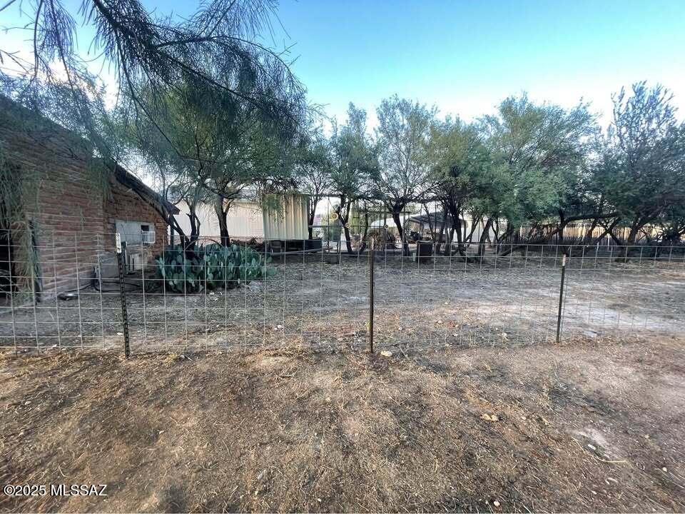 1094 North Pomerene Road Benson, AZ 85602 - Photo 14 of 48 a backyard of a house with lots of green space