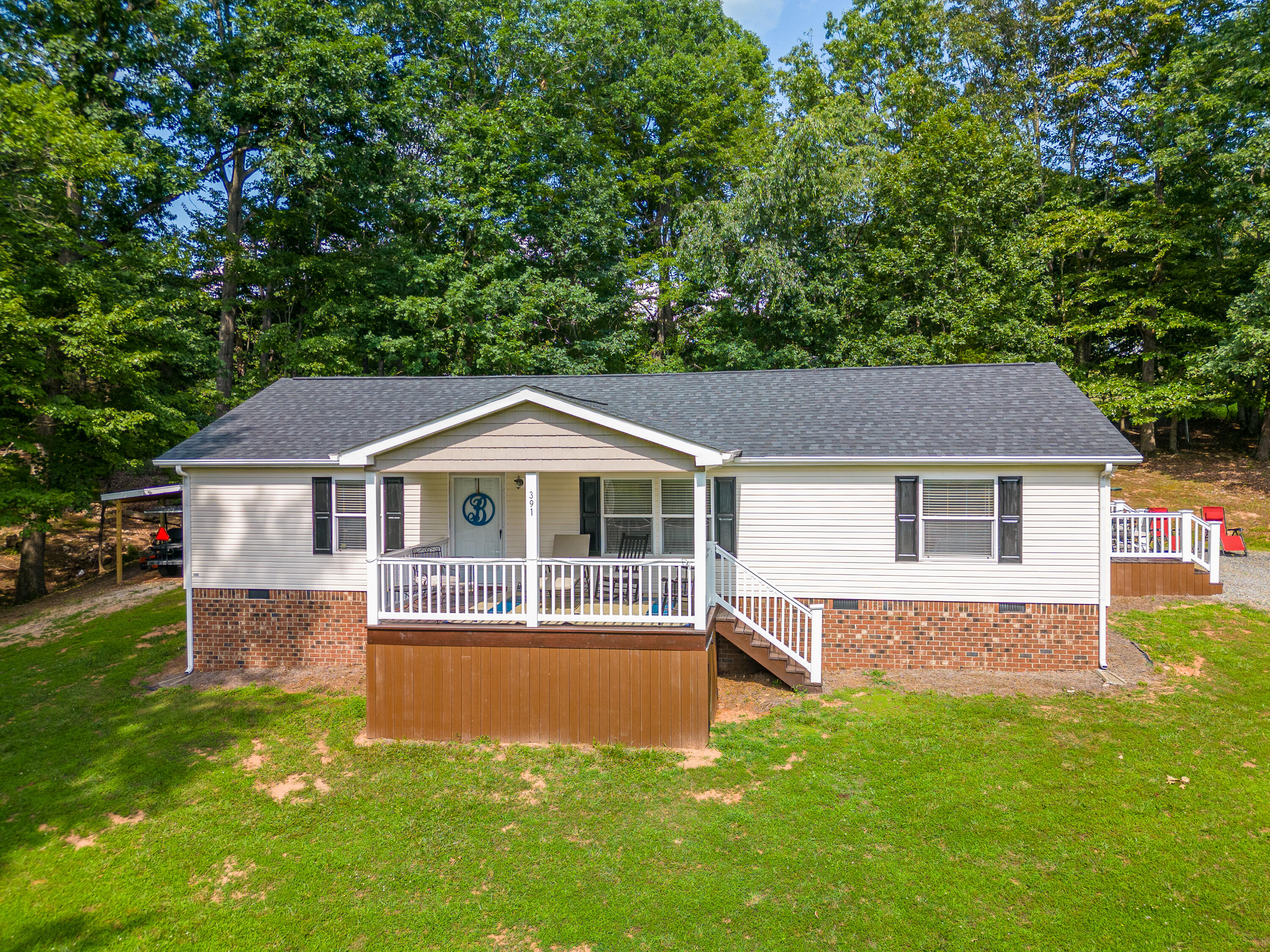 391 Cool Branch Road Penhook, VA 24137 - Photo 1 of 54 a front view of a house with a yard table and chairs
