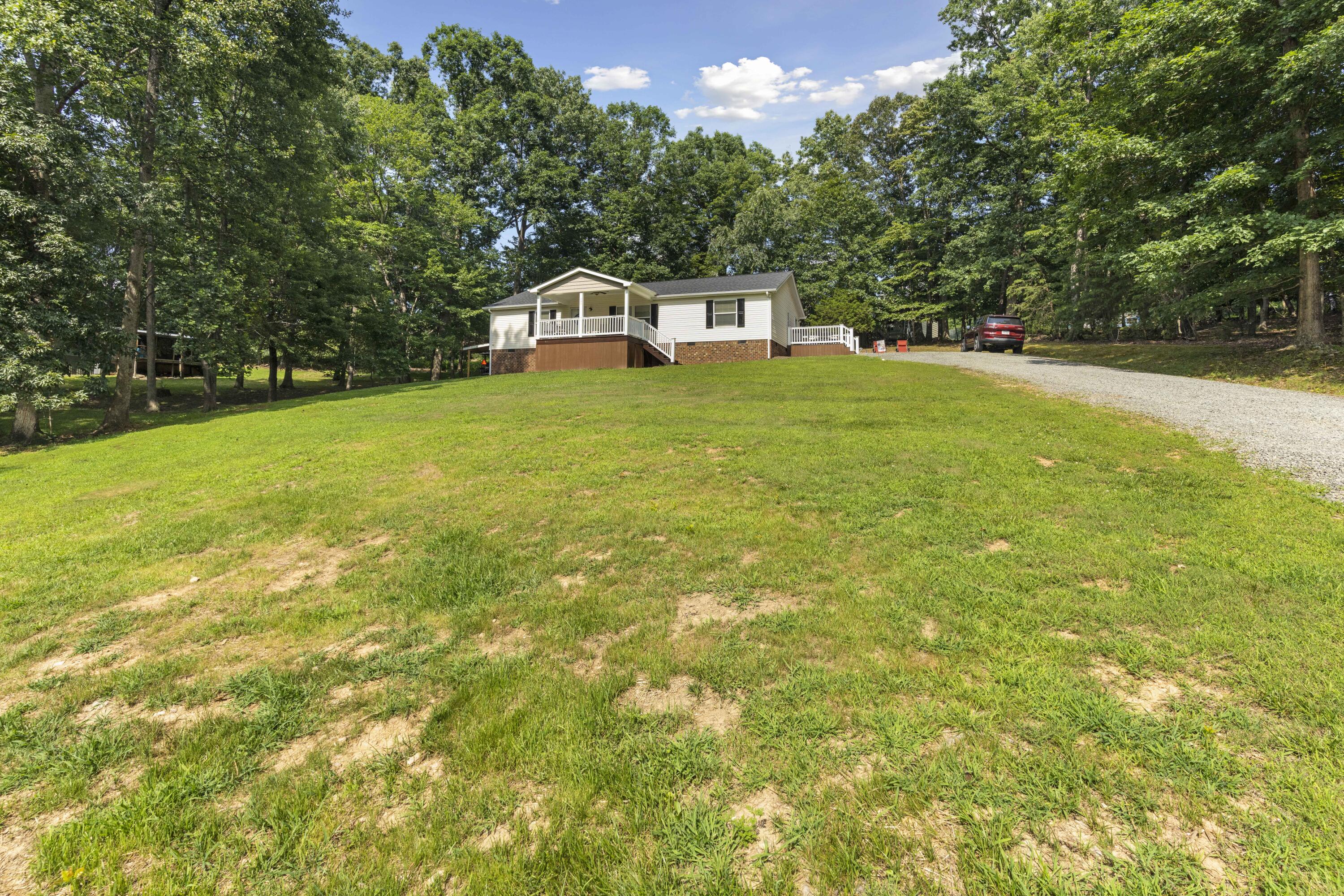 391 Cool Branch Road Penhook, VA 24137 - Photo 11 of 54 a house view with swimming pool in front of it