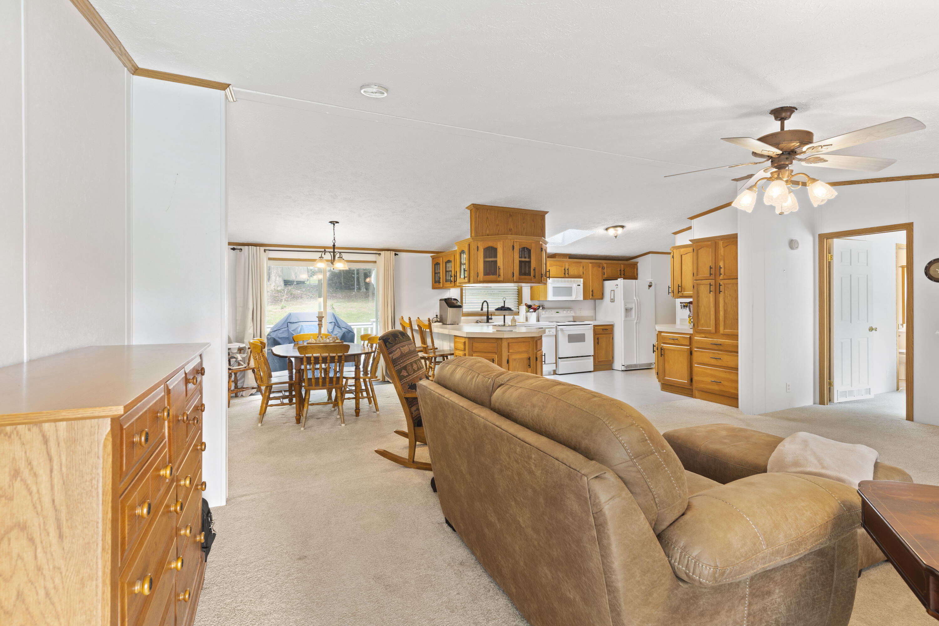 391 Cool Branch Road Penhook, VA 24137 - Photo 20 of 54 a living room with furniture kitchen view and a chandelier