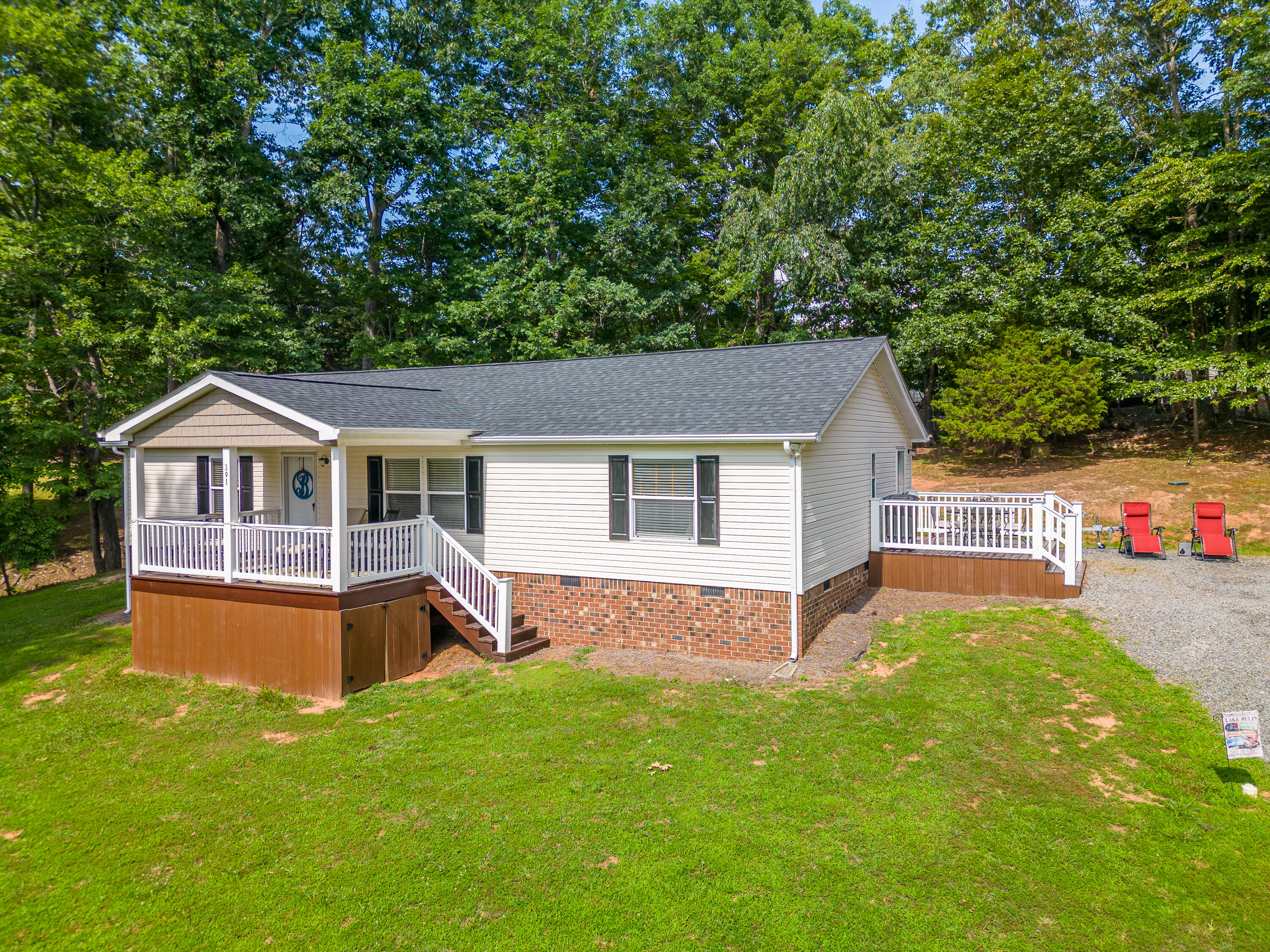 391 Cool Branch Road Penhook, VA 24137 - Photo 2 of 54 a front view of house with yard and green space