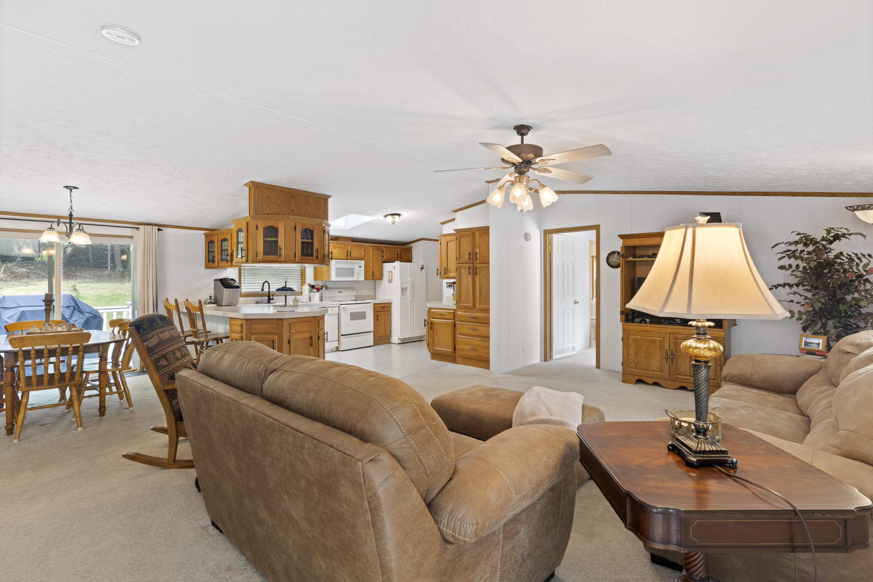 391 Cool Branch Road Penhook, VA 24137 - Photo 21 of 54 a living room with furniture a chandelier and a table