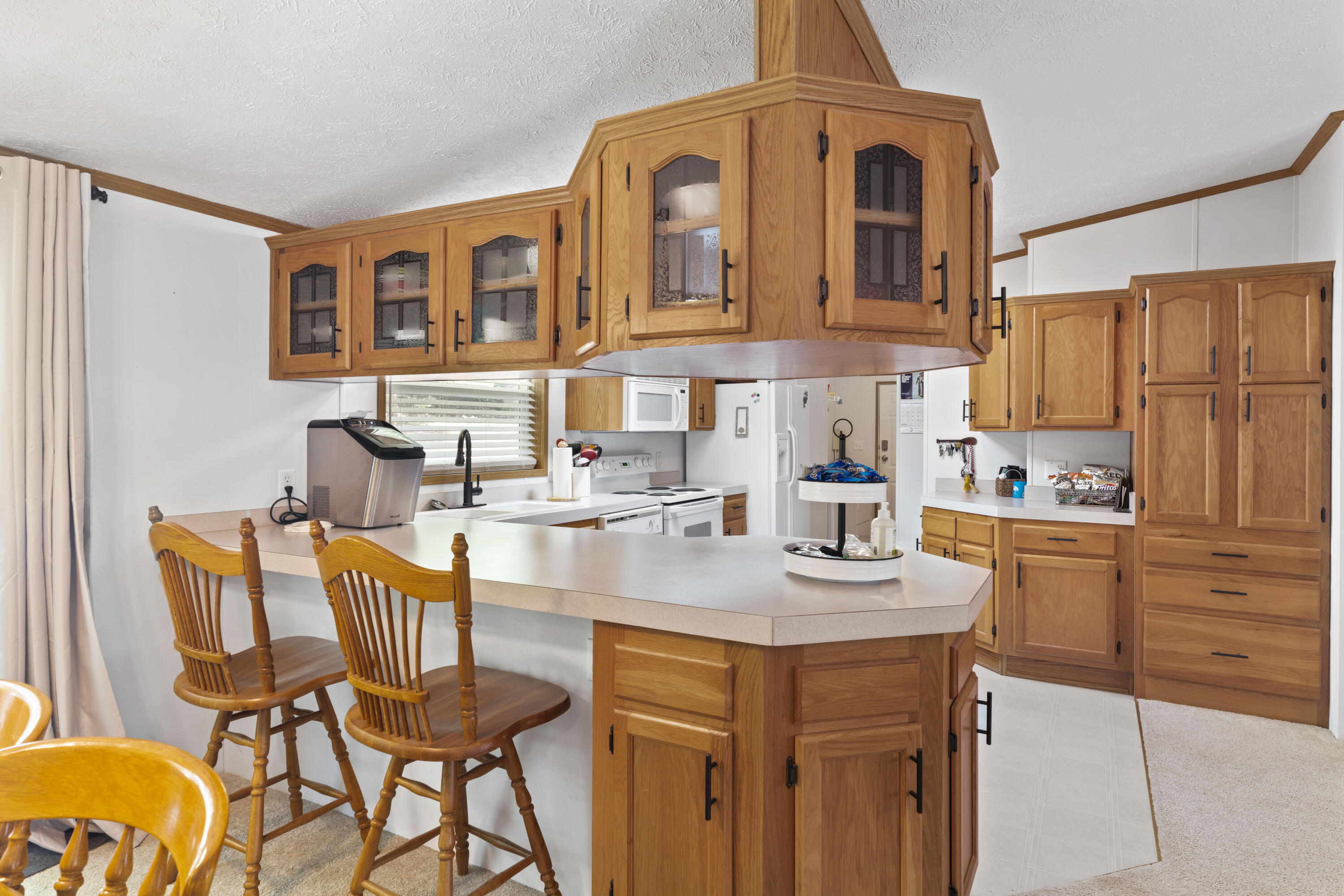 391 Cool Branch Road Penhook, VA 24137 - Photo 23 of 54 a kitchen with stainless steel appliances kitchen island granite countertop a table chairs and a refrigerator