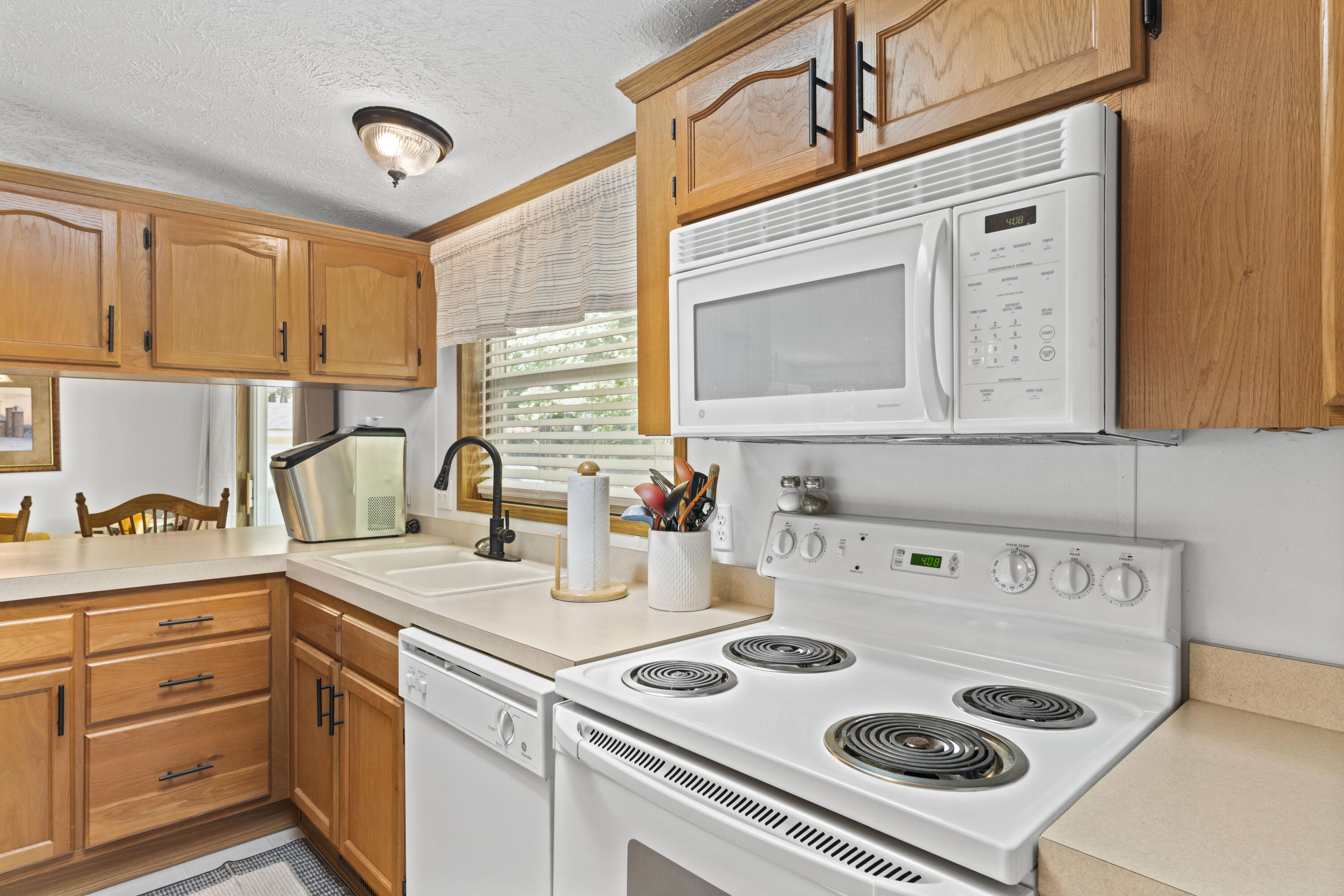 391 Cool Branch Road Penhook, VA 24137 - Photo 27 of 54 a kitchen with a stove a sink and a cabinets