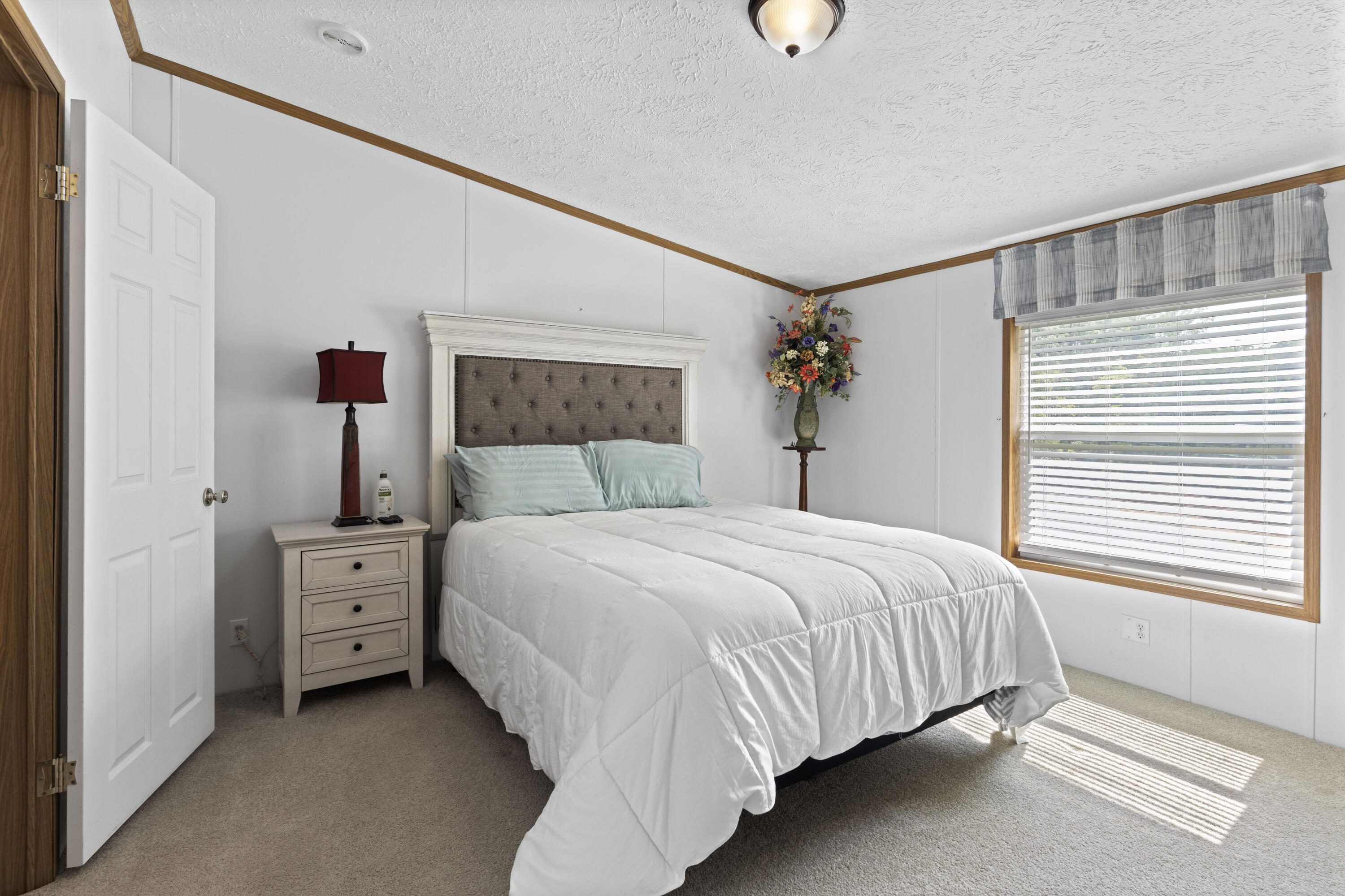 391 Cool Branch Road Penhook, VA 24137 - Photo 30 of 54 a bedroom with a large bed and a window
