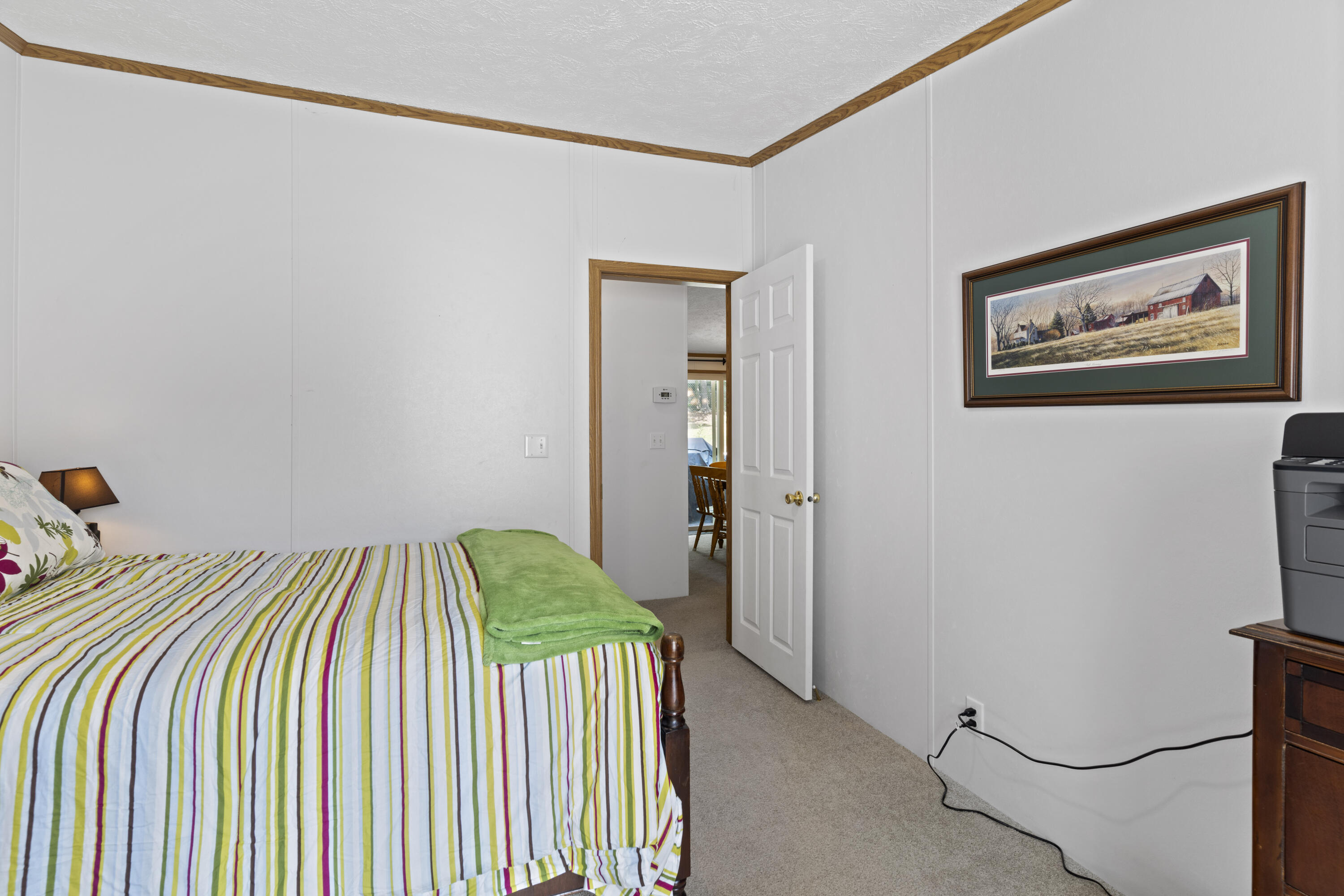 391 Cool Branch Road Penhook, VA 24137 - Photo 35 of 54 a bedroom with a bed and a painting on the wall