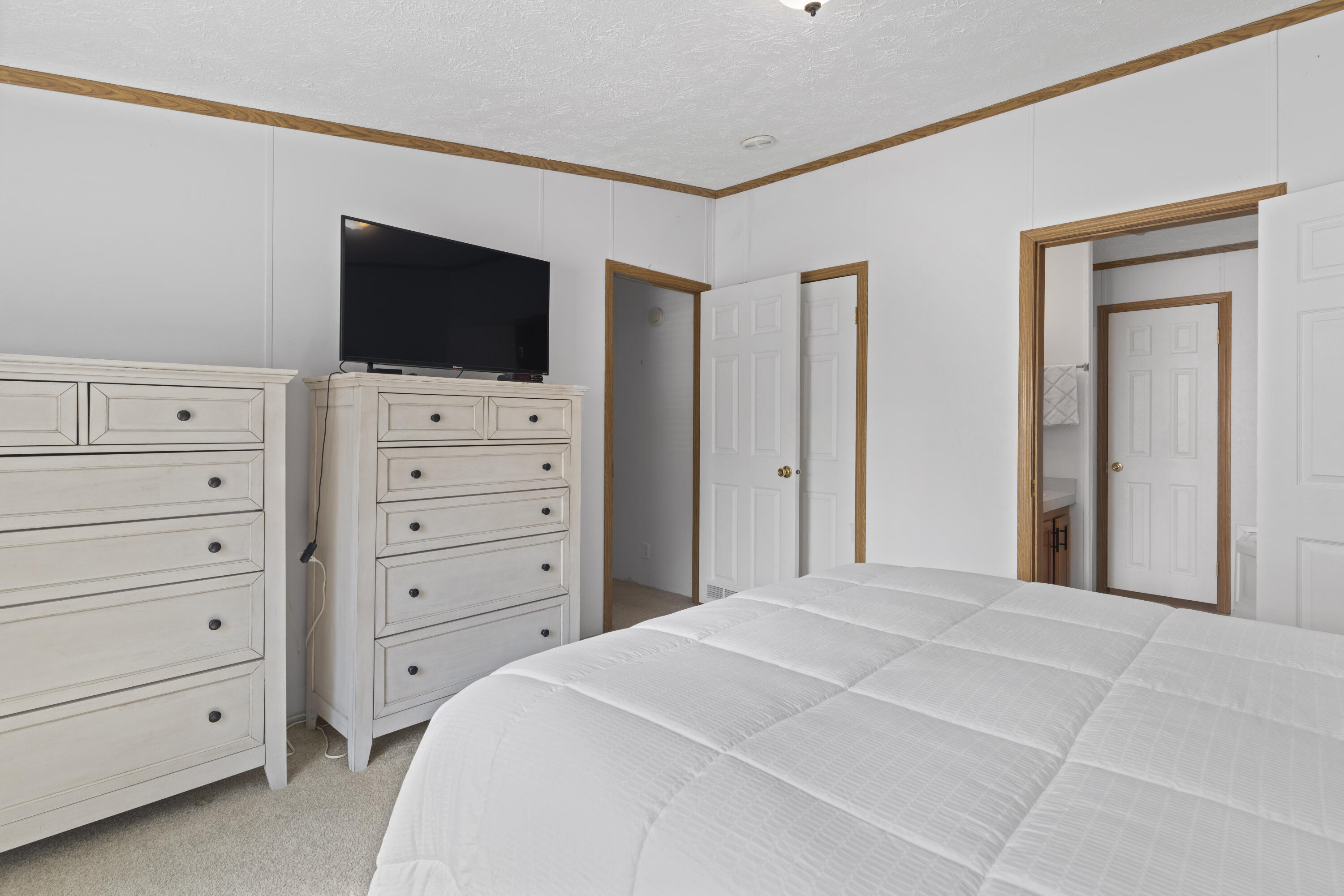 391 Cool Branch Road Penhook, VA 24137 - Photo 37 of 54 a bedroom with a large bed and flat screen tv