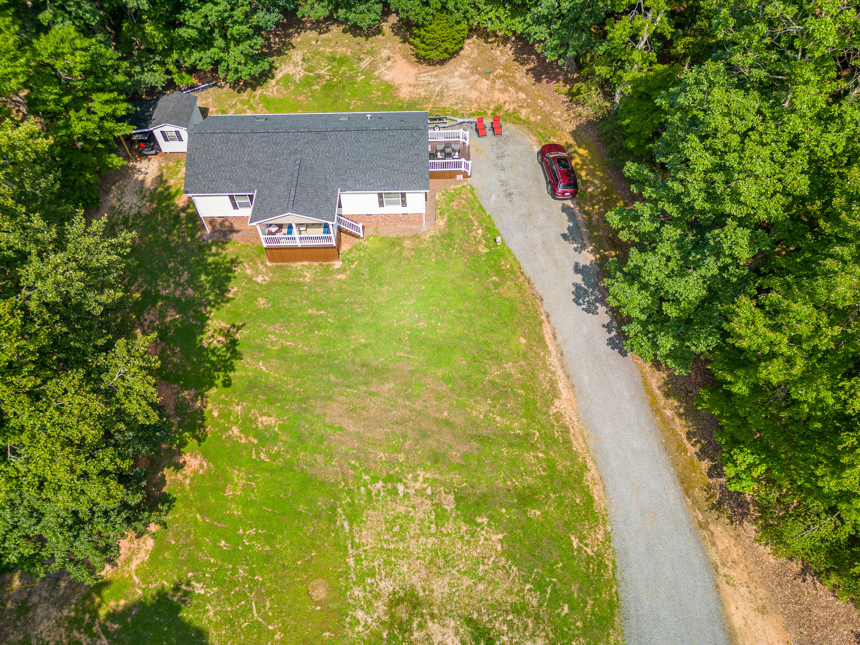 391 Cool Branch Road Penhook, VA 24137 - Photo 38 of 54 a aerial view of a house with swimming pool and large trees