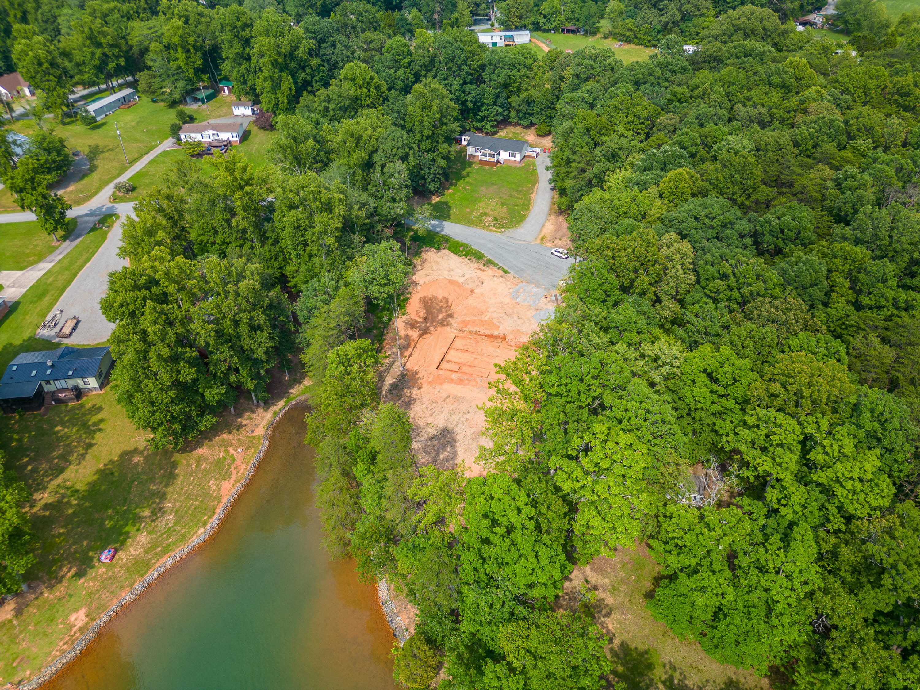 391 Cool Branch Road Penhook, VA 24137 - Photo 46 of 54 a yard with a house and a lake view