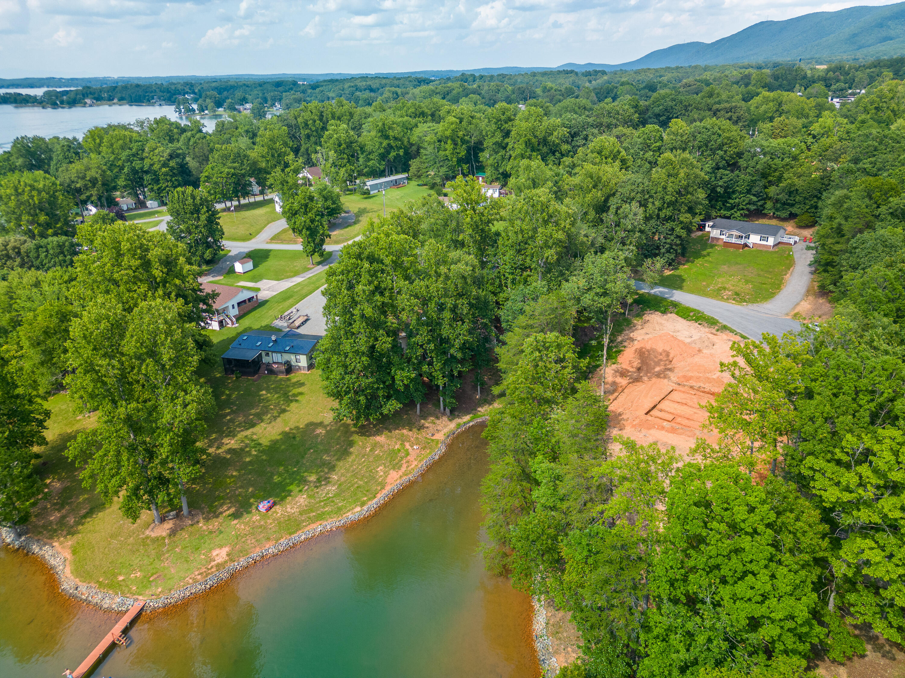 391 Cool Branch Road Penhook, VA 24137 - Photo 48 of 54 a view of a lake with a house