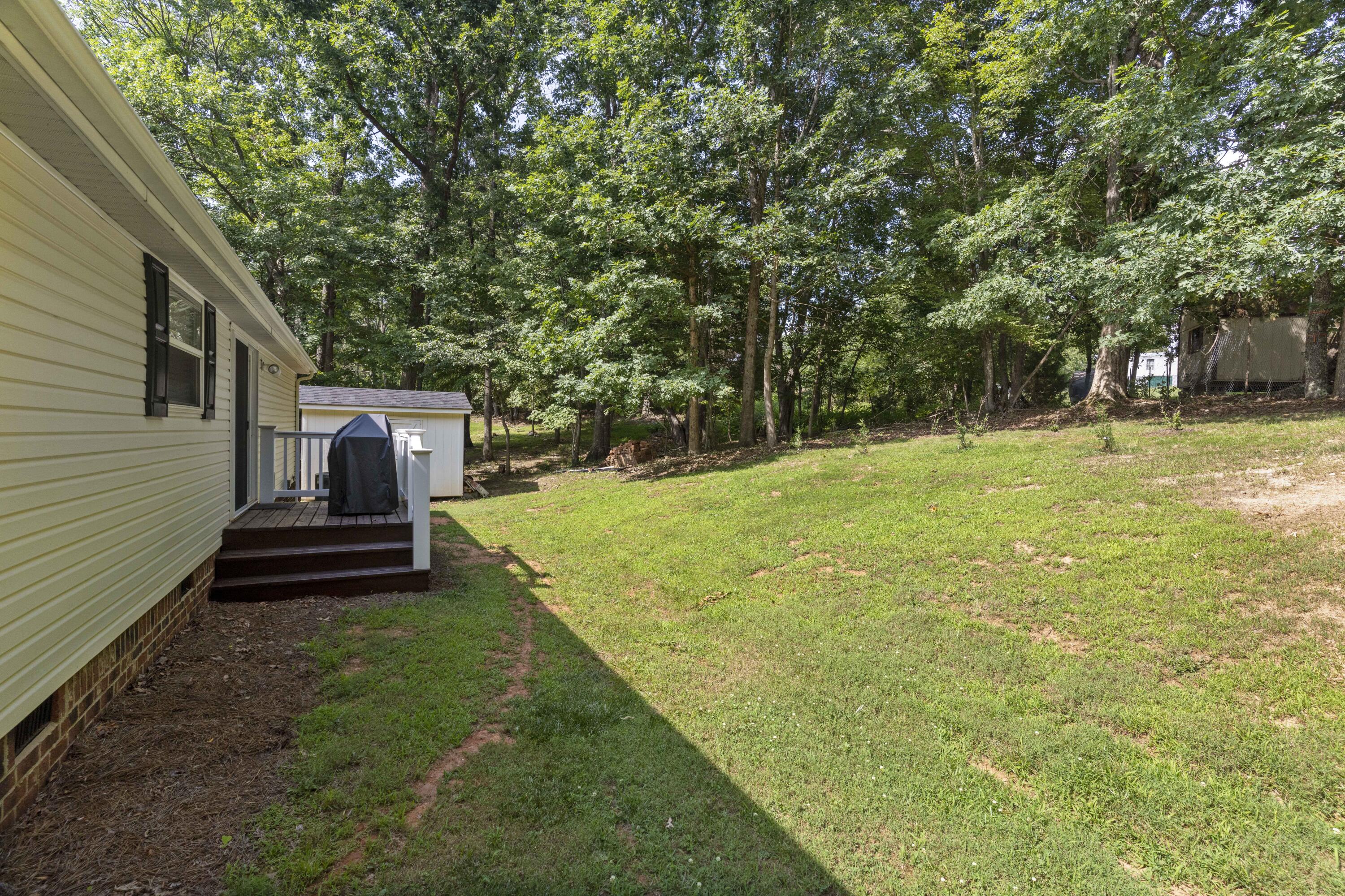 391 Cool Branch Road Penhook, VA 24137 - Photo 6 of 54 a view of a backyard with a garden