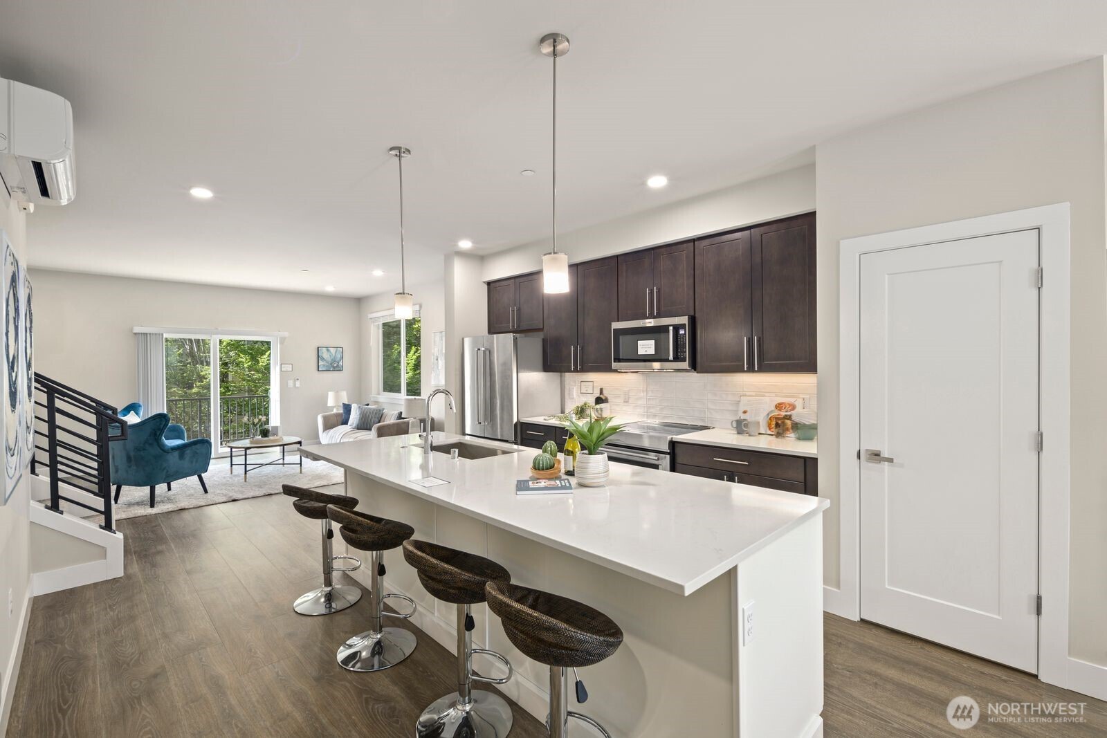 826 238th Place Southeast, Unit F Bothell, WA 98021 - Photo 5 of 39 a large kitchen with a counter space a sink appliances and dining table