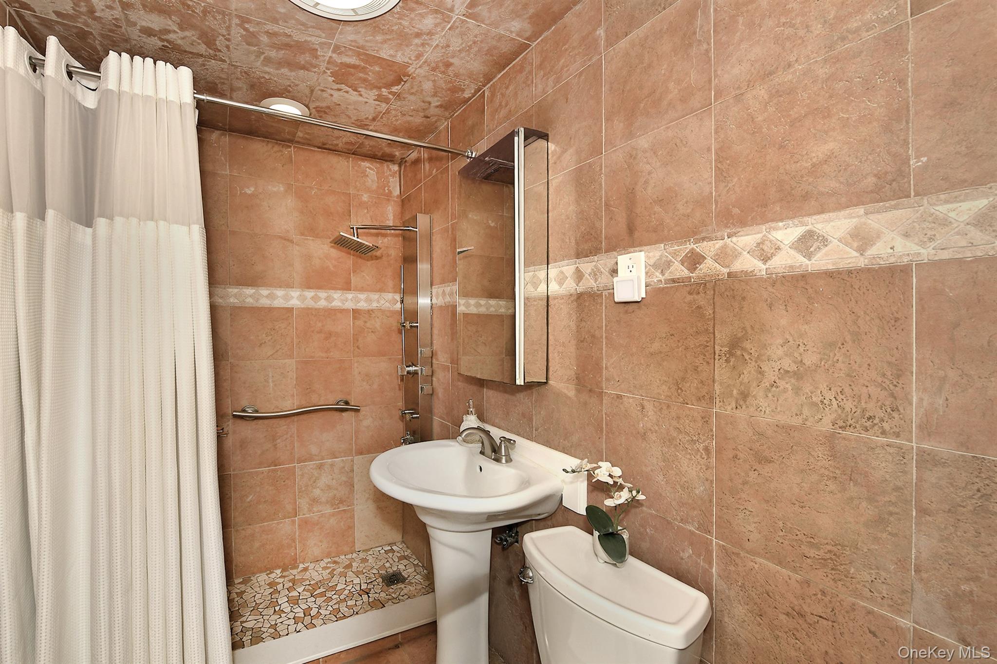 156 Farmedge Road Levittown, NY 11756 - Photo 13 of 22 a bathroom with a sink toilet and shower