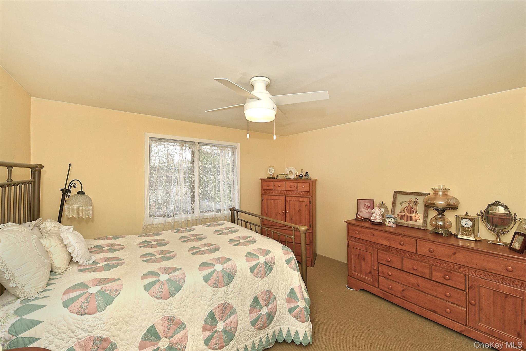 156 Farmedge Road Levittown, NY 11756 - Photo 15 of 22 a bedroom with a bed and a chandelier