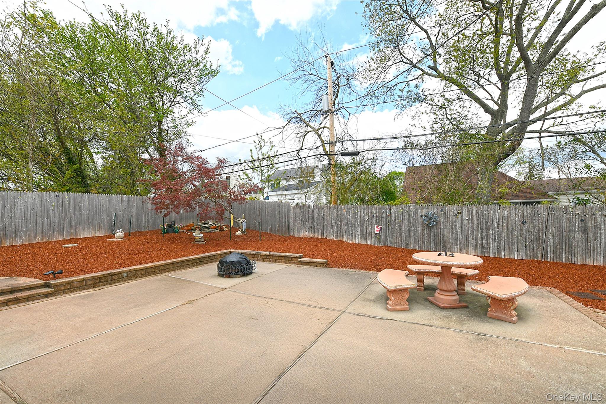 156 Farmedge Road Levittown, NY 11756 - Photo 19 of 22 a backyard of a house with table and chairs