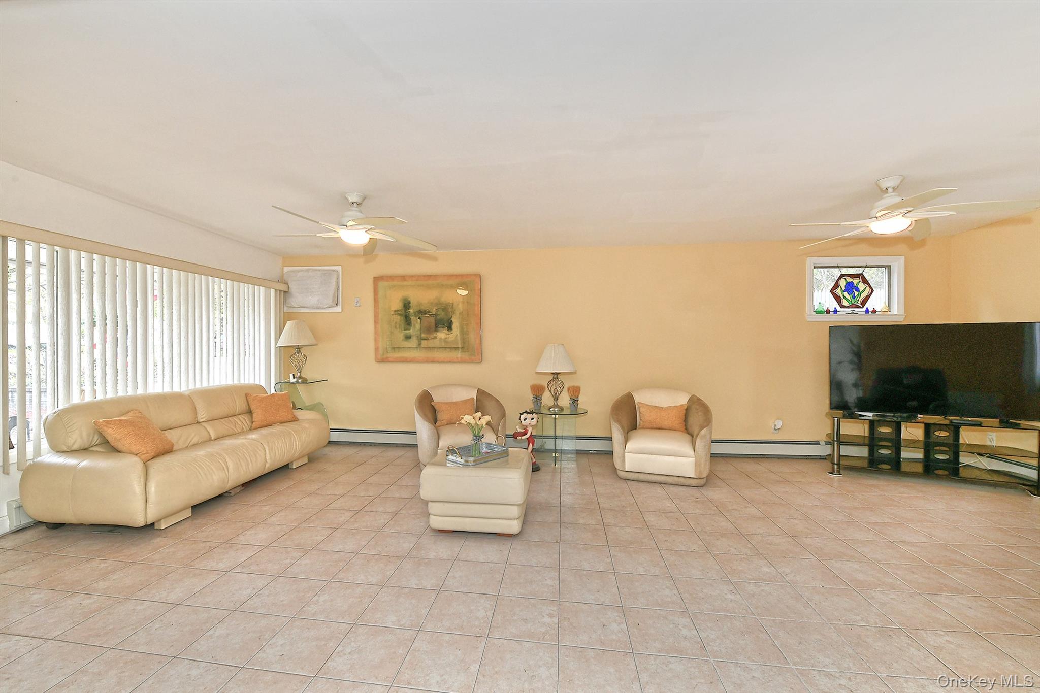 156 Farmedge Road Levittown, NY 11756 - Photo 4 of 22 a living room with furniture and a flat screen tv