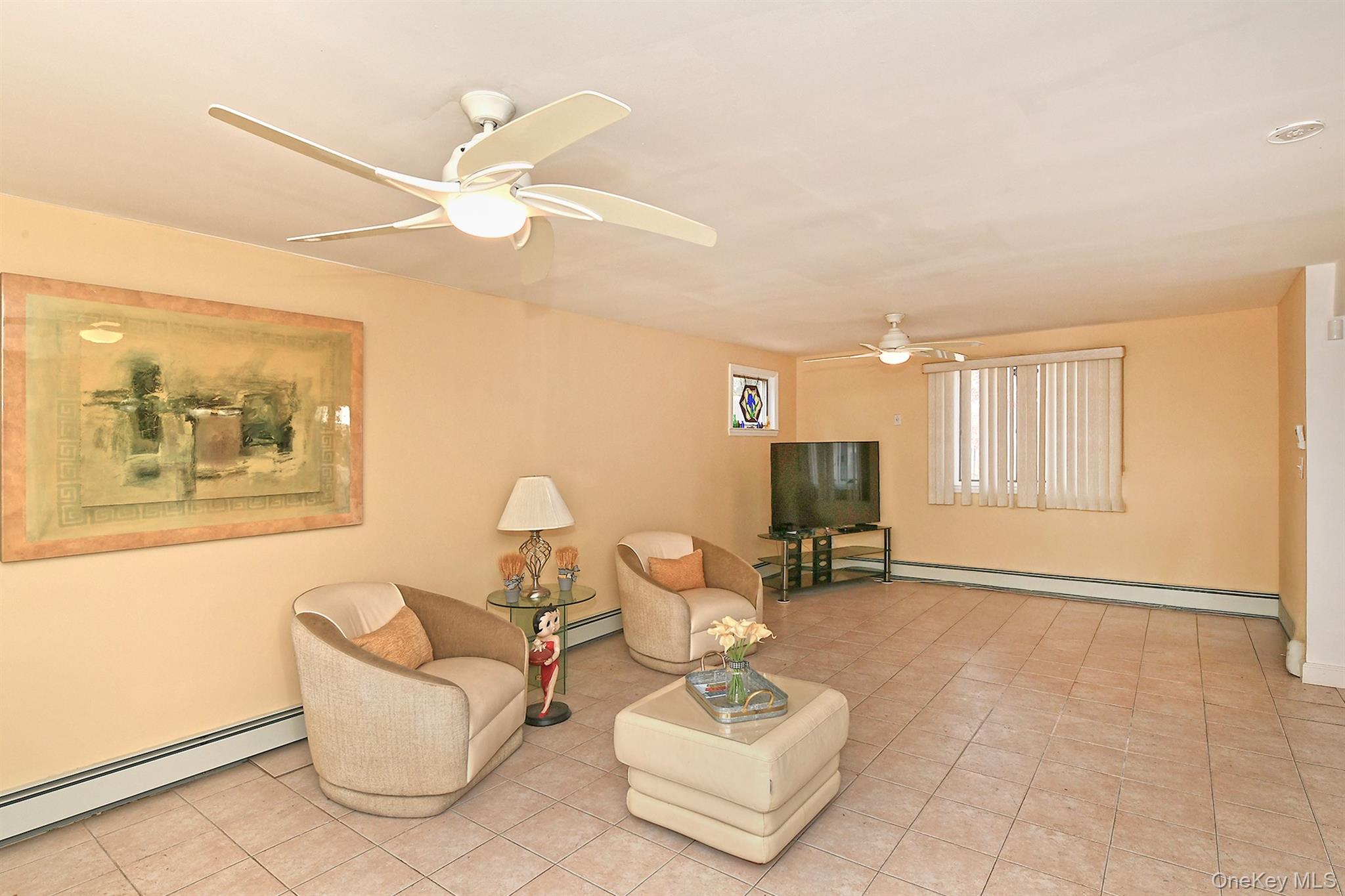 156 Farmedge Road Levittown, NY 11756 - Photo 5 of 22 a living room with furniture and a flat screen tv