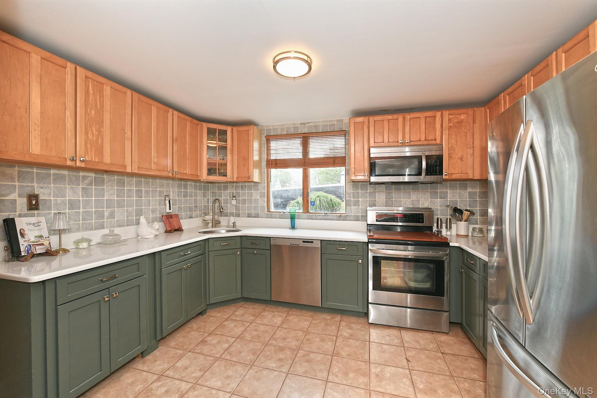156 Farmedge Road Levittown, NY 11756 - Photo 8 of 22 a kitchen with stainless steel appliances granite countertop a sink stove and refrigerator
