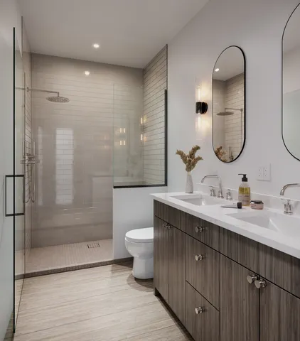 a bathroom with a double vanity sink mirror and shower
