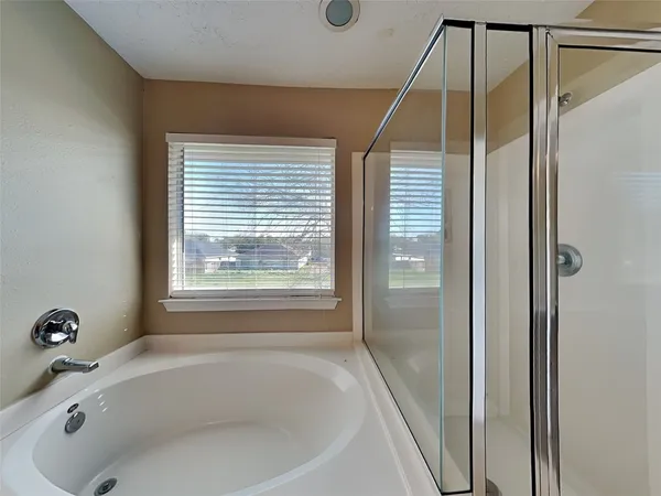 a bathroom with a tub and shower