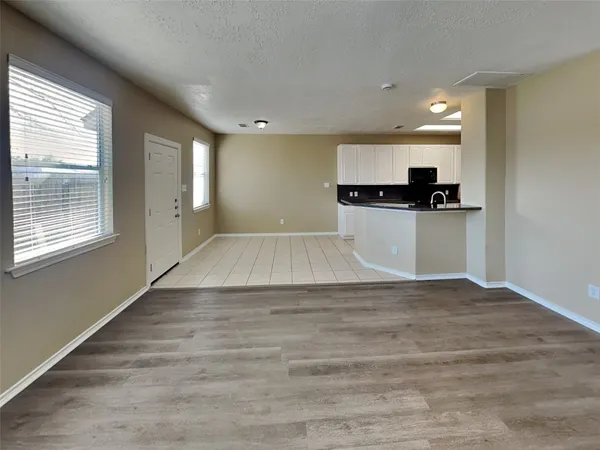 a view of kitchen with kitchen island a sink wooden floor and a stove