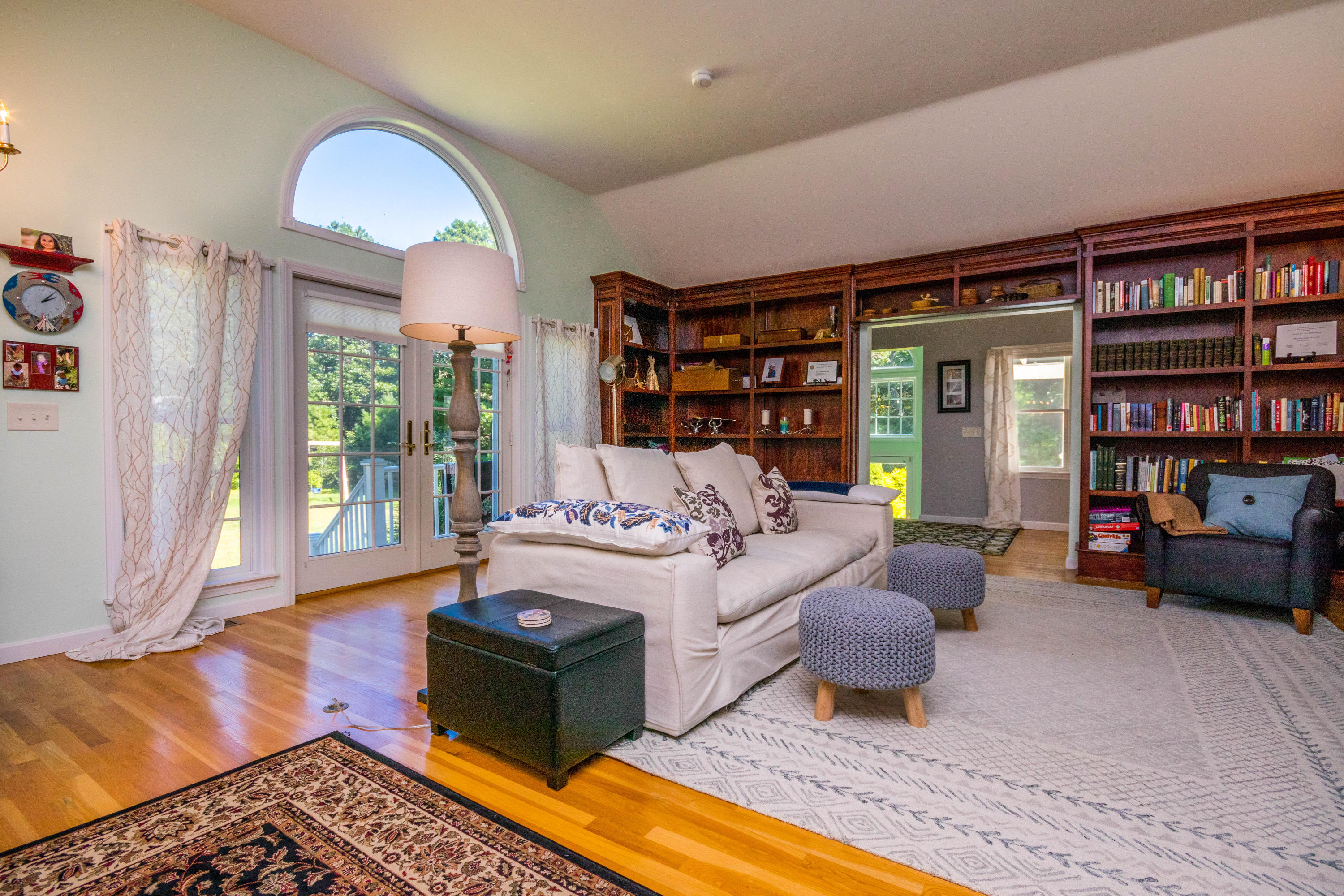 52 Lovells Road Cotuit, MA 02635 - Photo 17 of 51 a living room with furniture and a book shelf