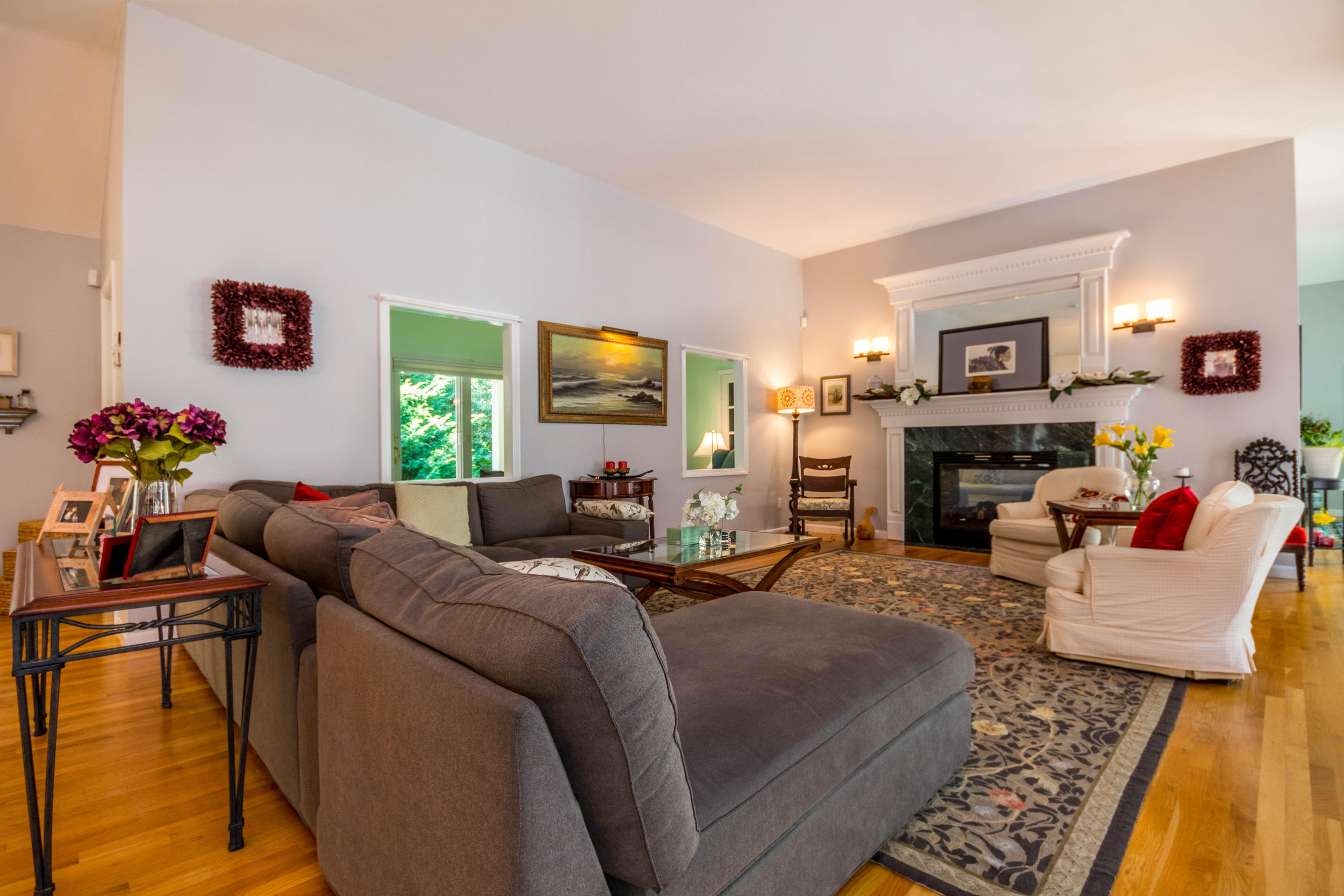 52 Lovells Road Cotuit, MA 02635 - Photo 9 of 51 a living room with furniture fireplace and a large window