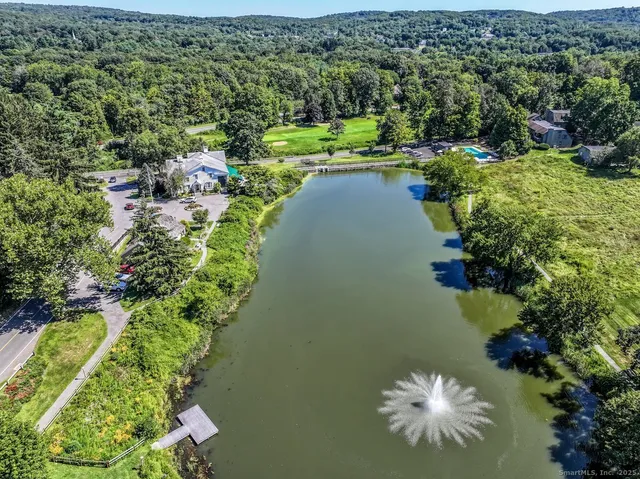 an aerial view of a house with a yard and lake view