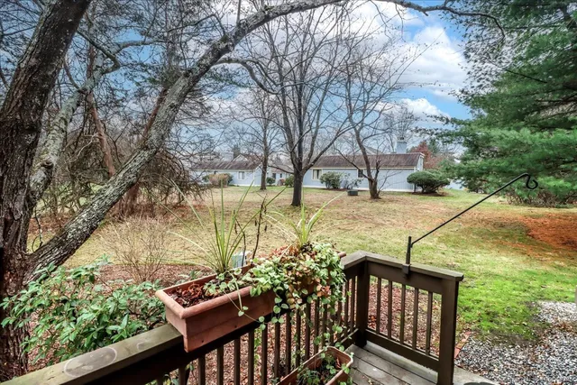 a view of a patio with two chairs next to a yard