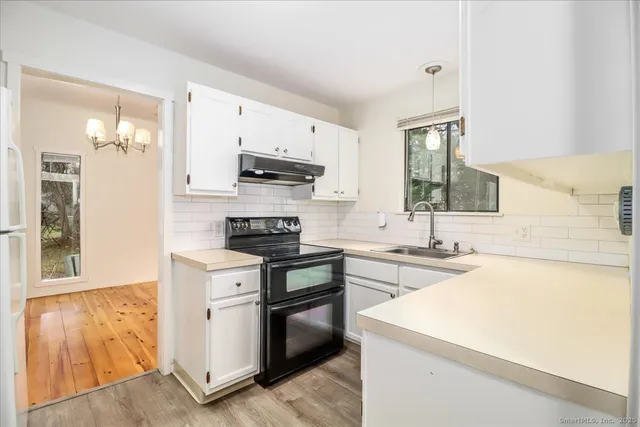 a kitchen with a stove a sink and a refrigerator