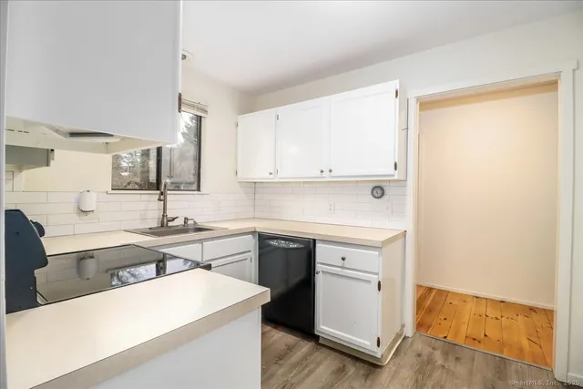 a kitchen with a sink a stove and cabinets