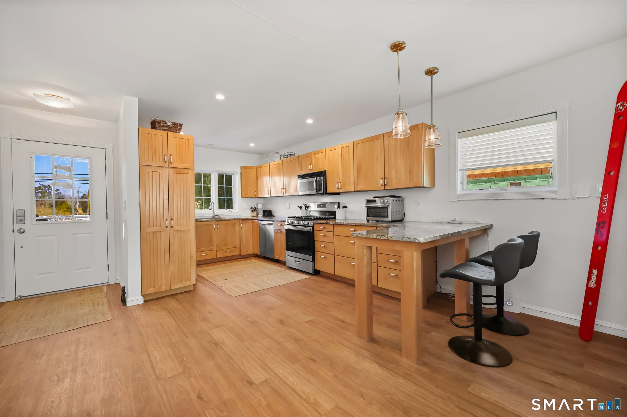 1895 Fairfield Beach Road Fairfield, CT 06824 - Photo 2 of 18 a kitchen with stainless steel appliances granite countertop a refrigerator and a stove top oven