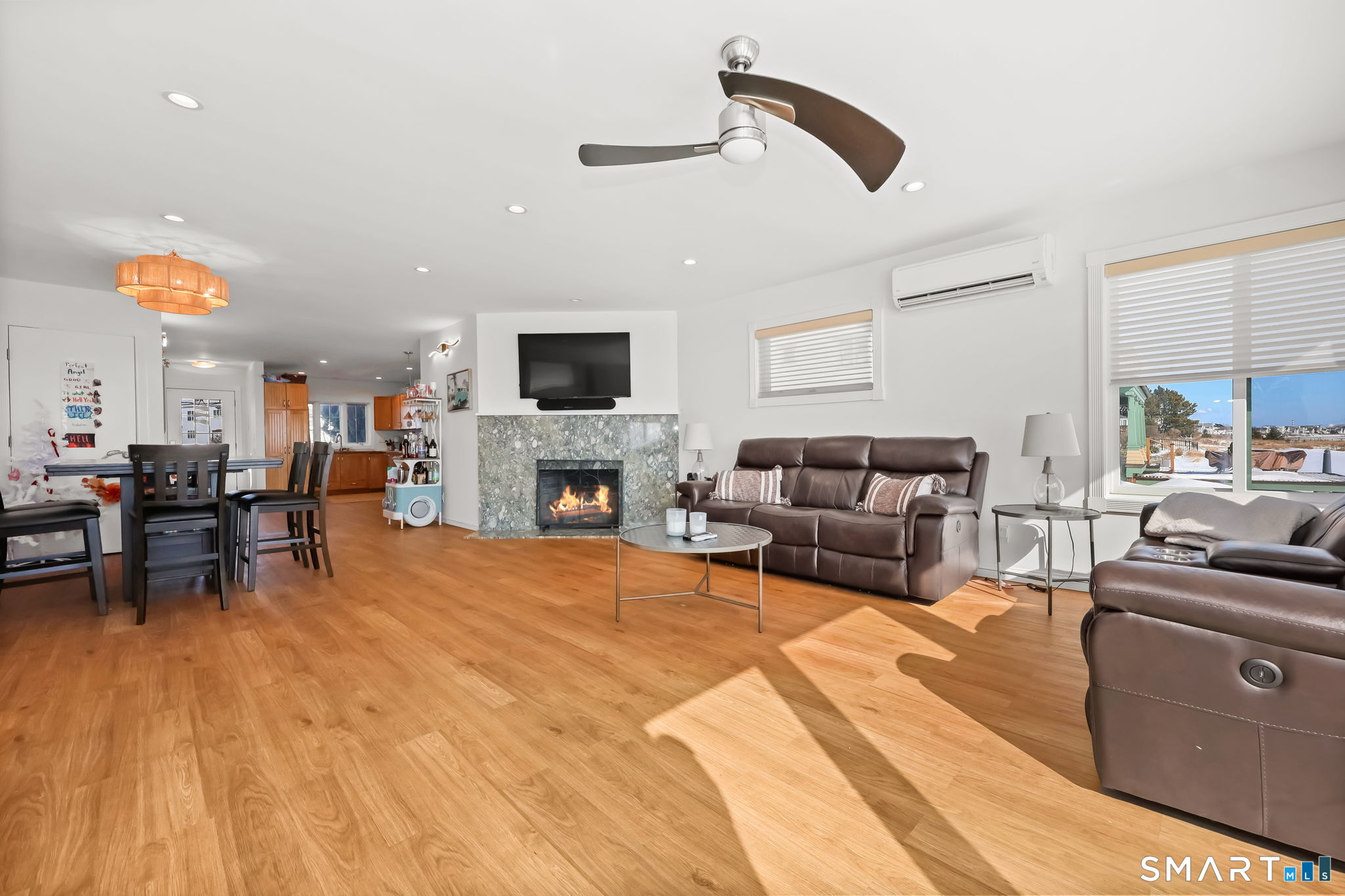 1895 Fairfield Beach Road Fairfield, CT 06824 - Photo 6 of 18 a living room with furniture and a fireplace