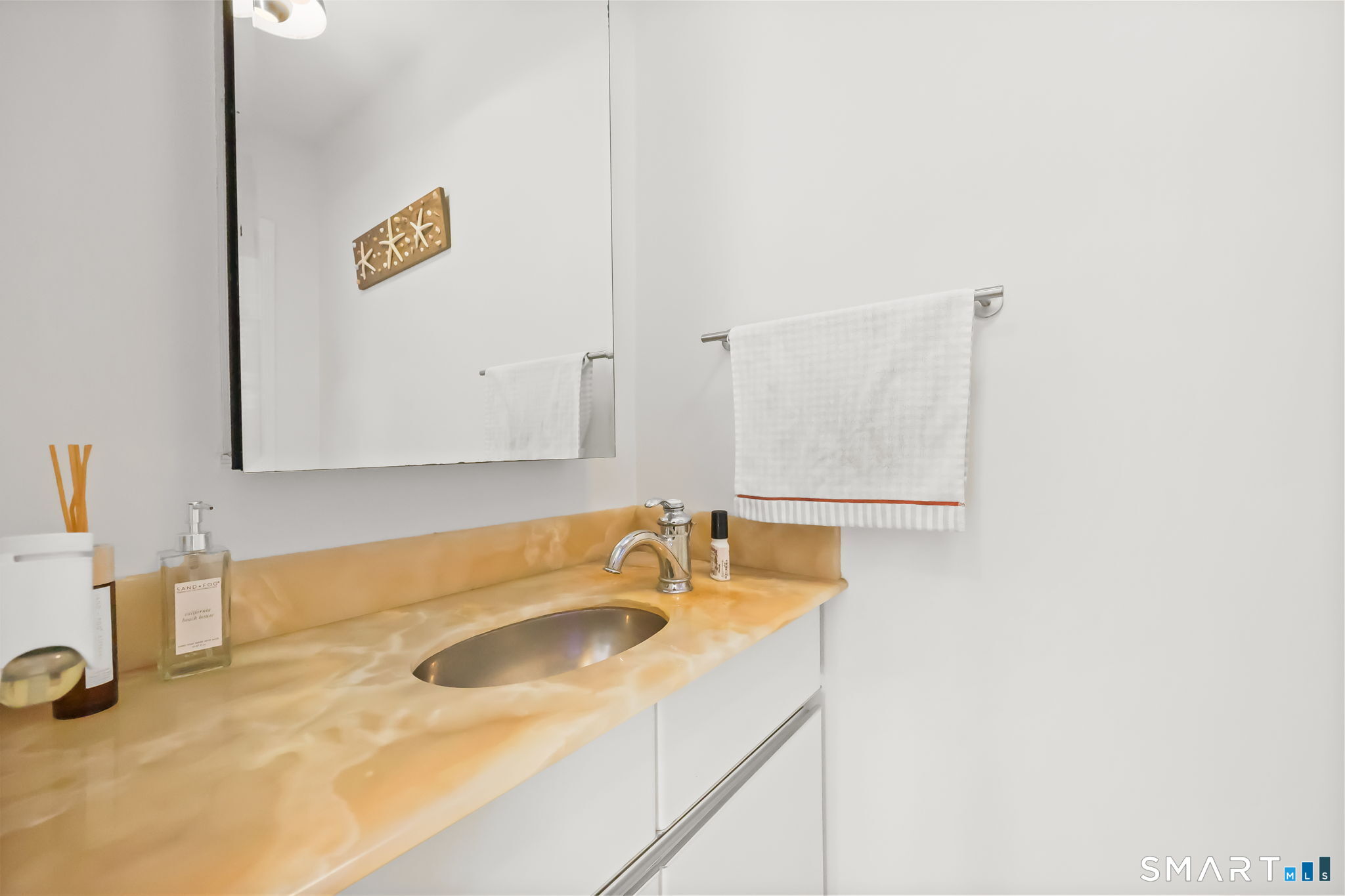 1895 Fairfield Beach Road Fairfield, CT 06824 - Photo 7 of 18 a bathroom with a sink and a mirror