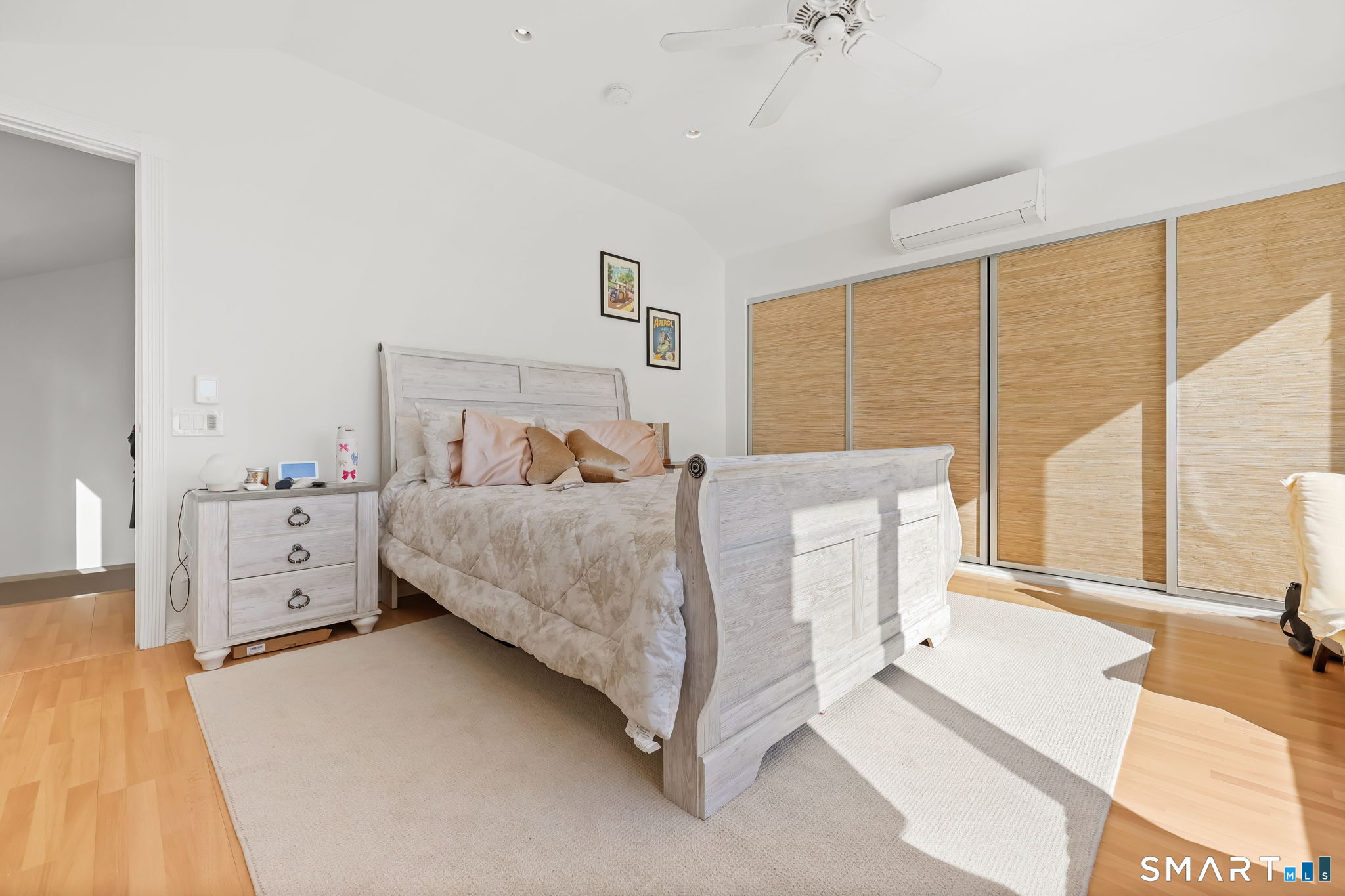 1895 Fairfield Beach Road Fairfield, CT 06824 - Photo 9 of 18 a bedroom with a large bed and a large window