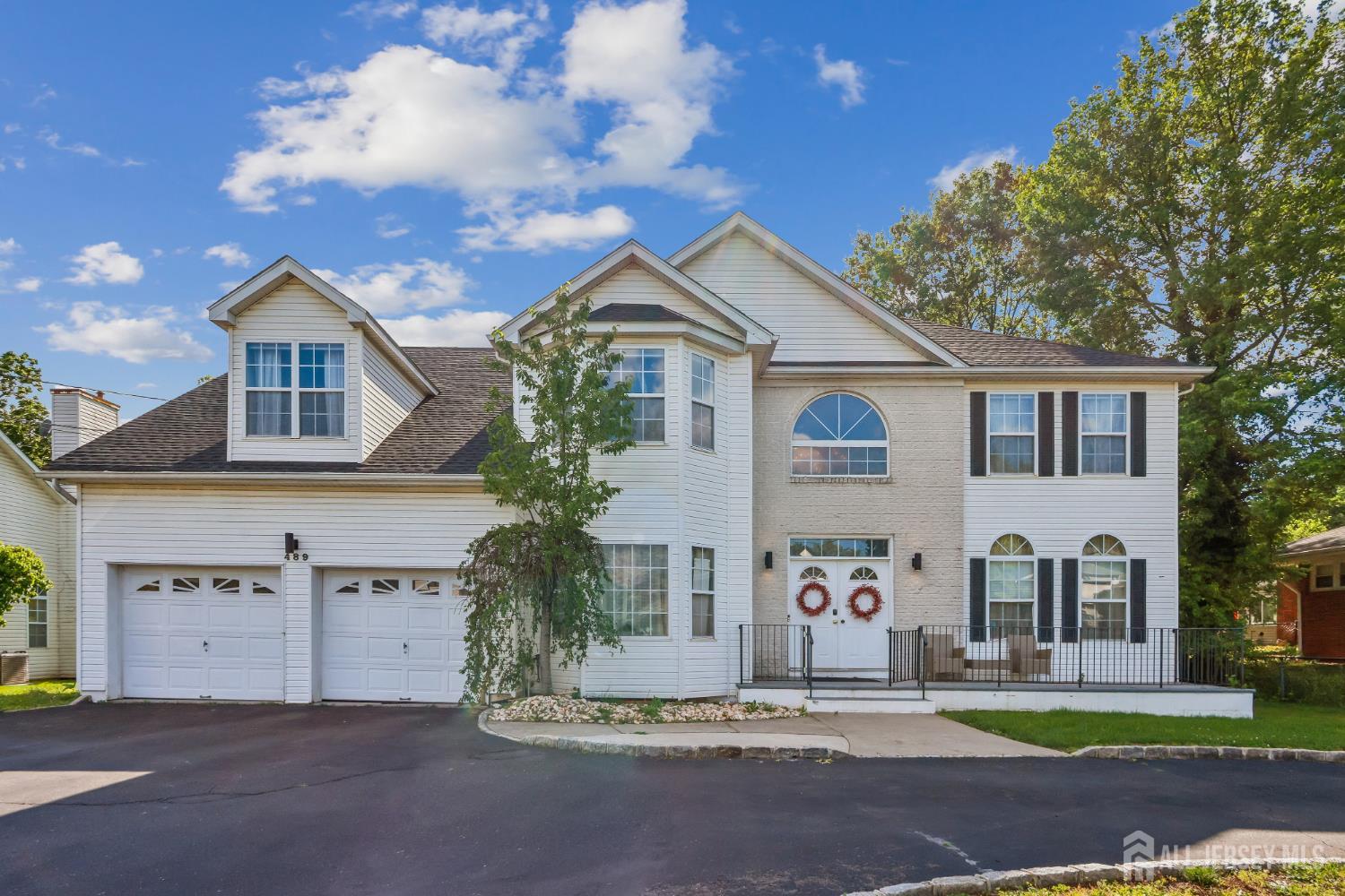 489 Plainfield Road Edison, NJ 08820 - Photo 3 of 39 a view of a white house with a large space next to a yard
