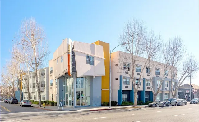 a city street lined with buildings and trees
