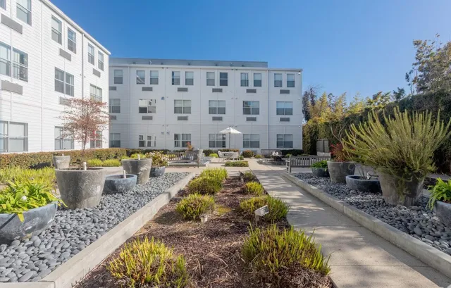a swimming pool with outdoor seating and yard