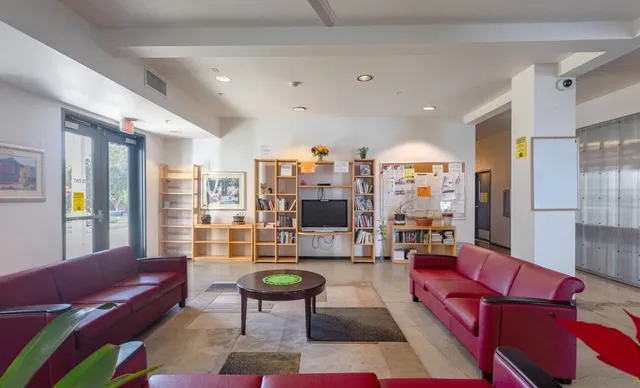 a living room with furniture a rug and a chandelier