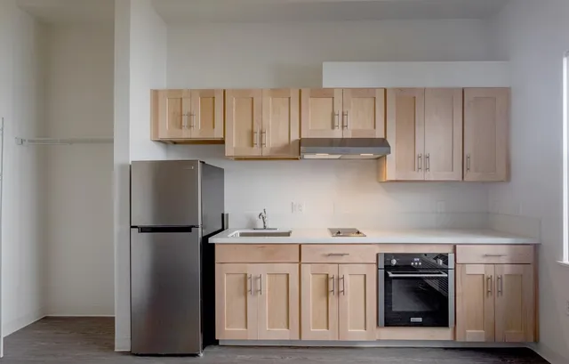 a kitchen with stainless steel appliances granite countertop a refrigerator sink and cabinets