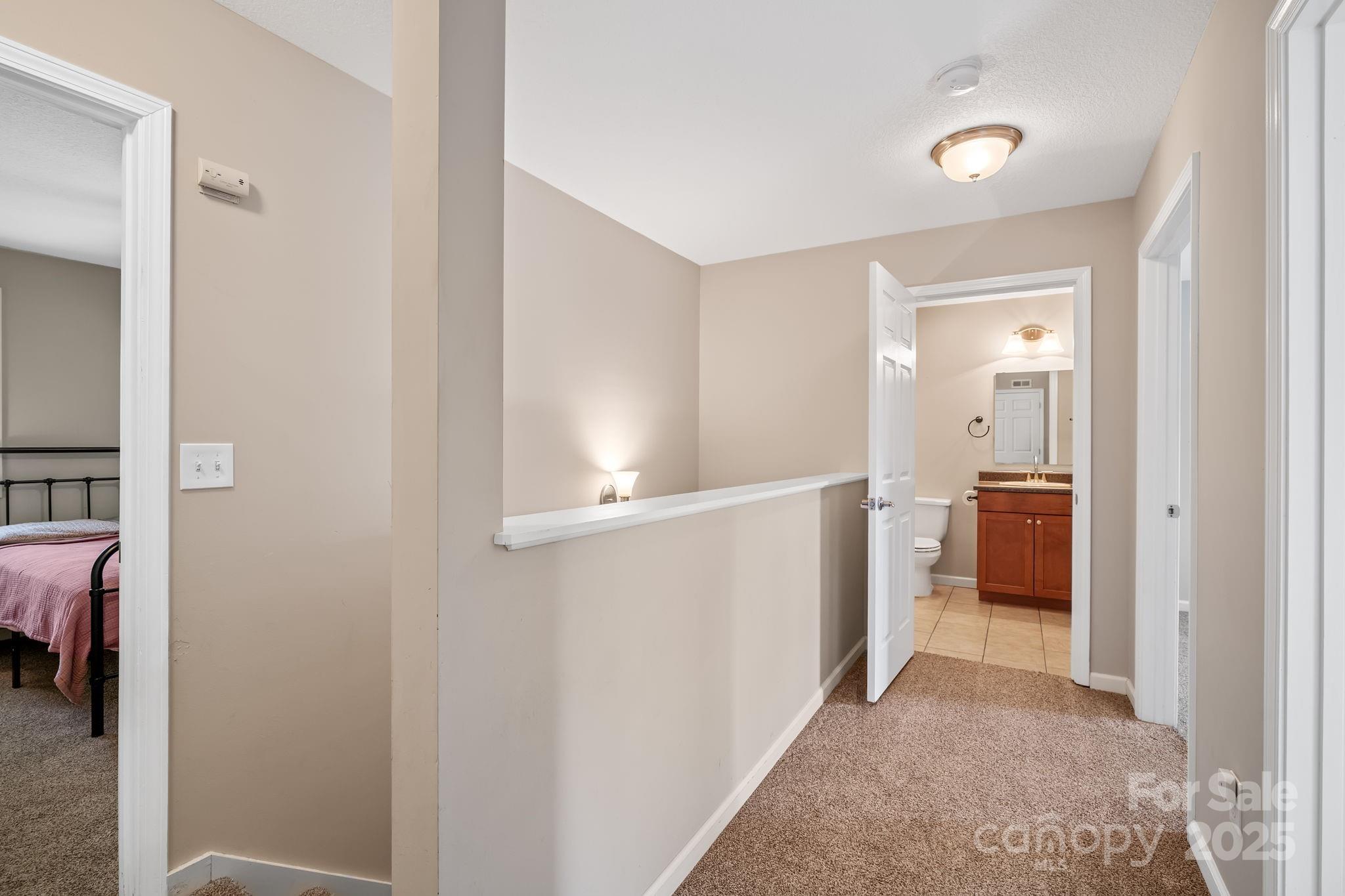 33 English Ivy Road Asheville, NC 28806 - Photo 15 of 27 a view of a hallway with bathroom and a sink