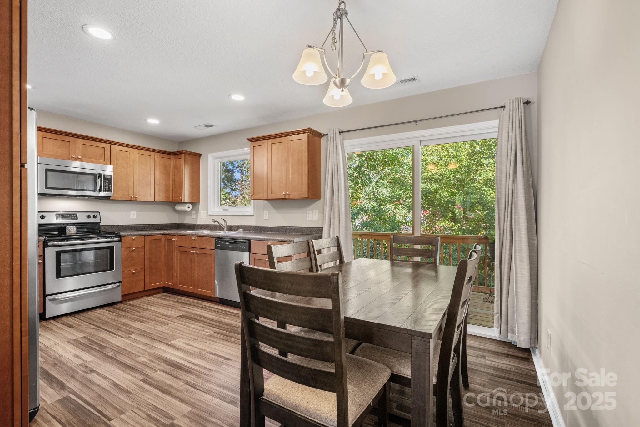 33 English Ivy Road Asheville, NC 28806 - Photo 7 of 27 a kitchen with a table chairs microwave and cabinets